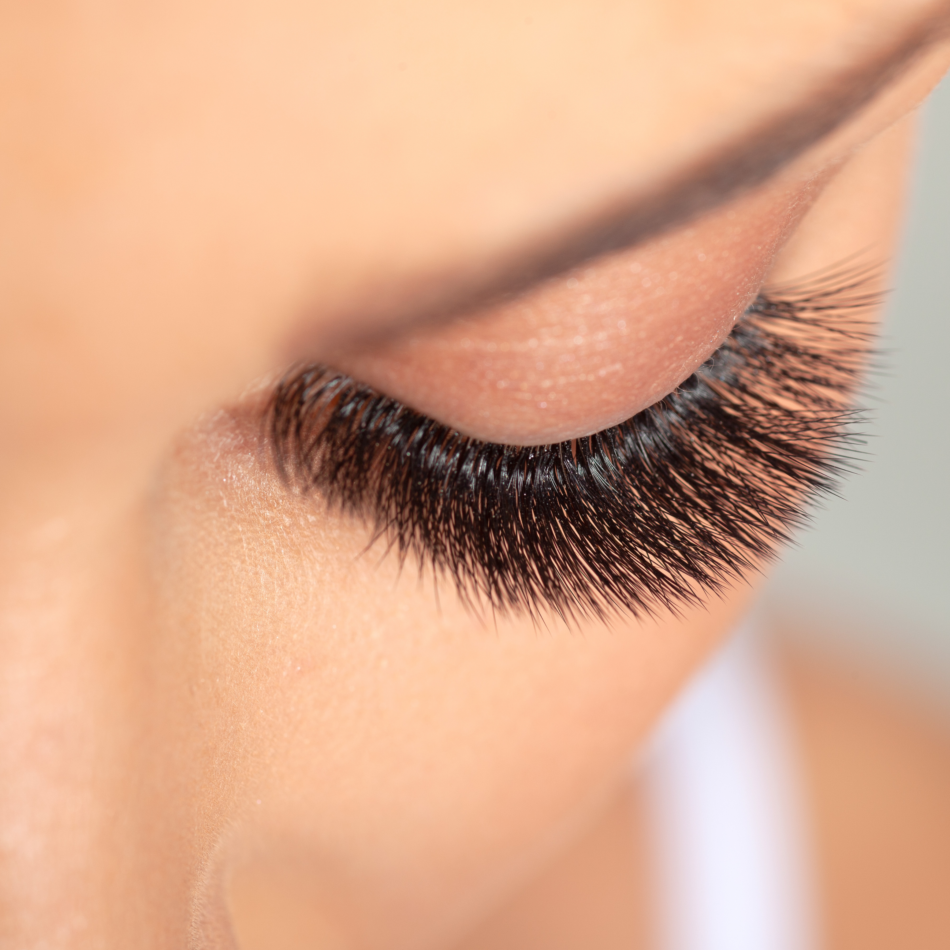 Close-up of beautifully applied DIY eyelash extensions showcasing added volume and length.