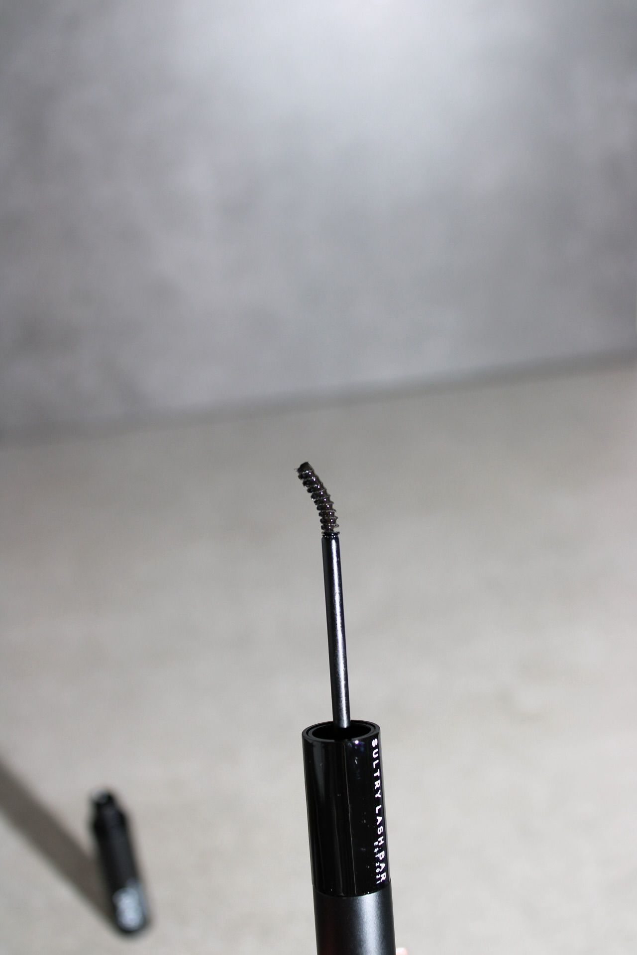 eyelash glue with brush on a neutral background