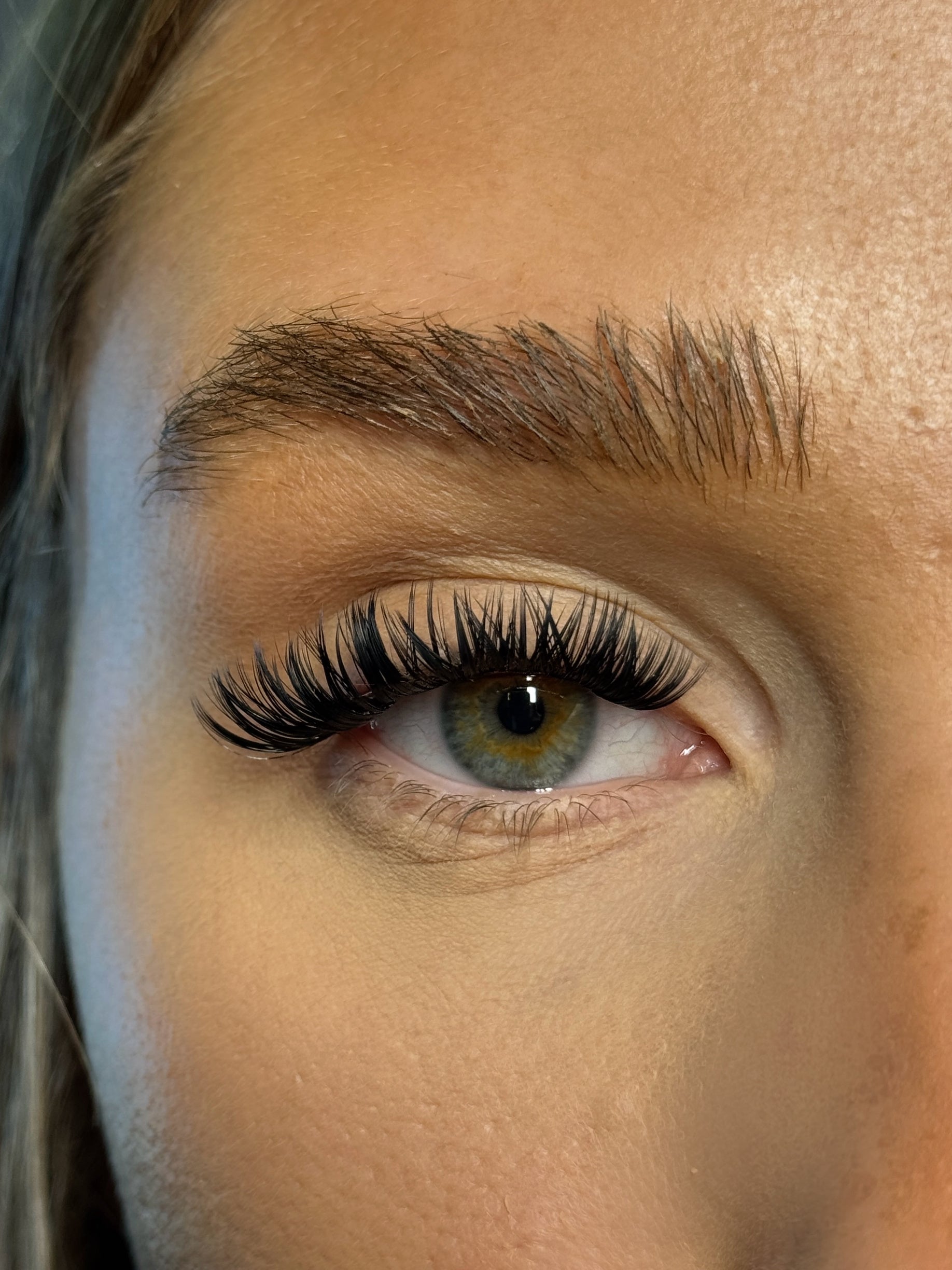 Close-up of a person's eye with long eyelashes