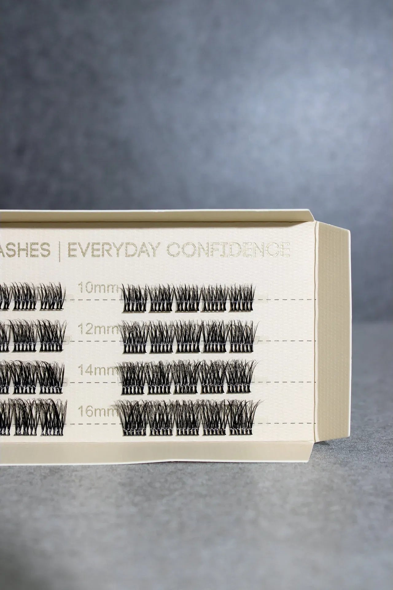 Eyelash packaging with different sizes on a gray background
