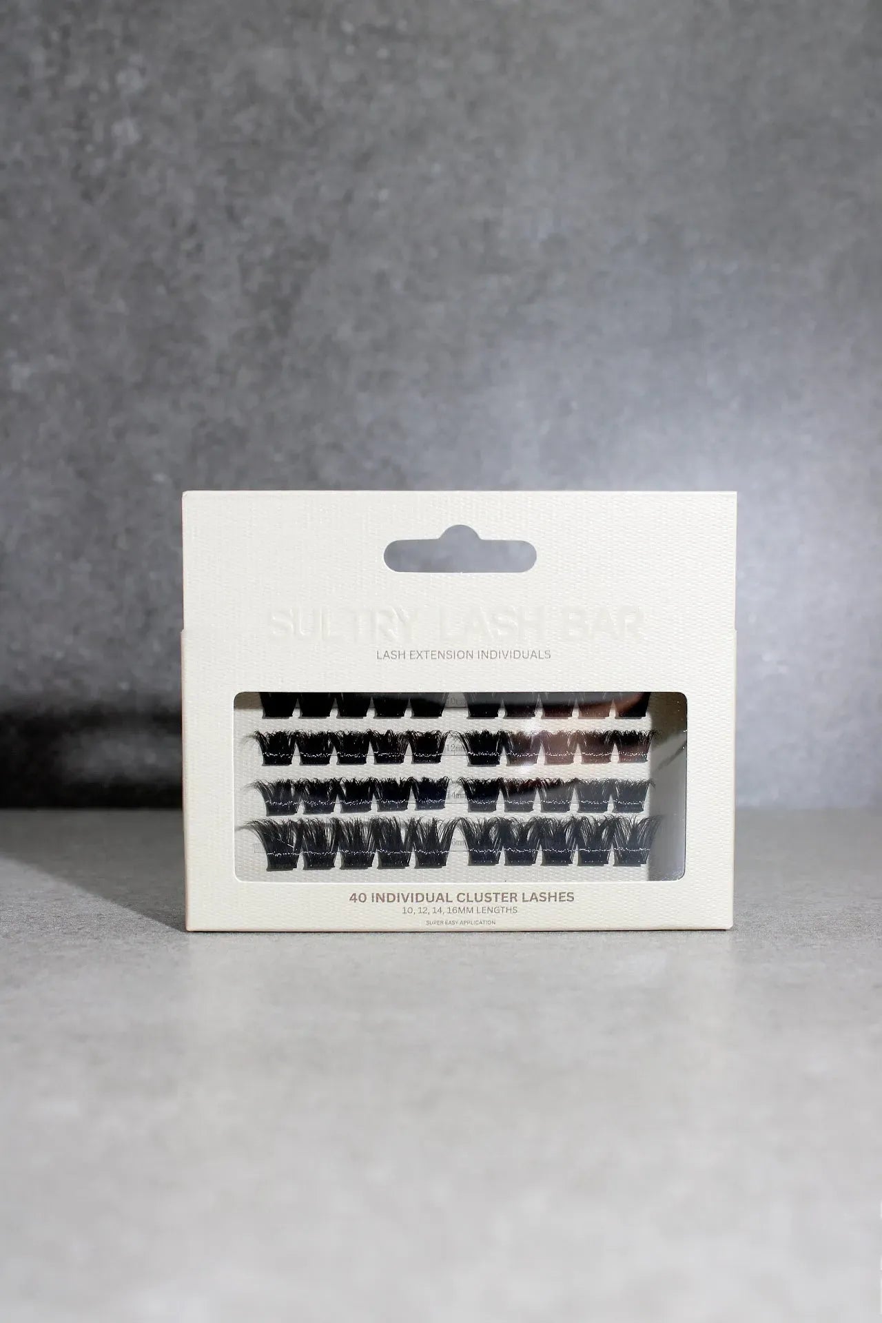 Eyelash packaging with false eyelashes on a gray background