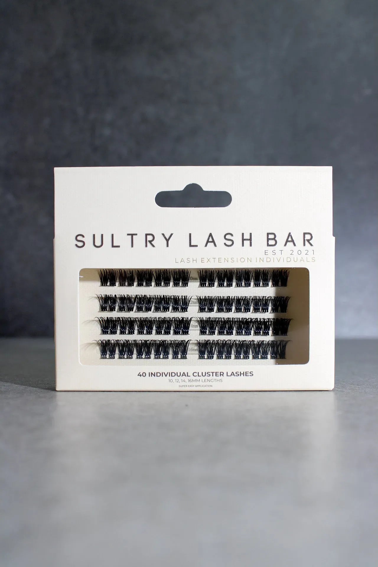 Sultry Lash Bar lash packaging on a gray background