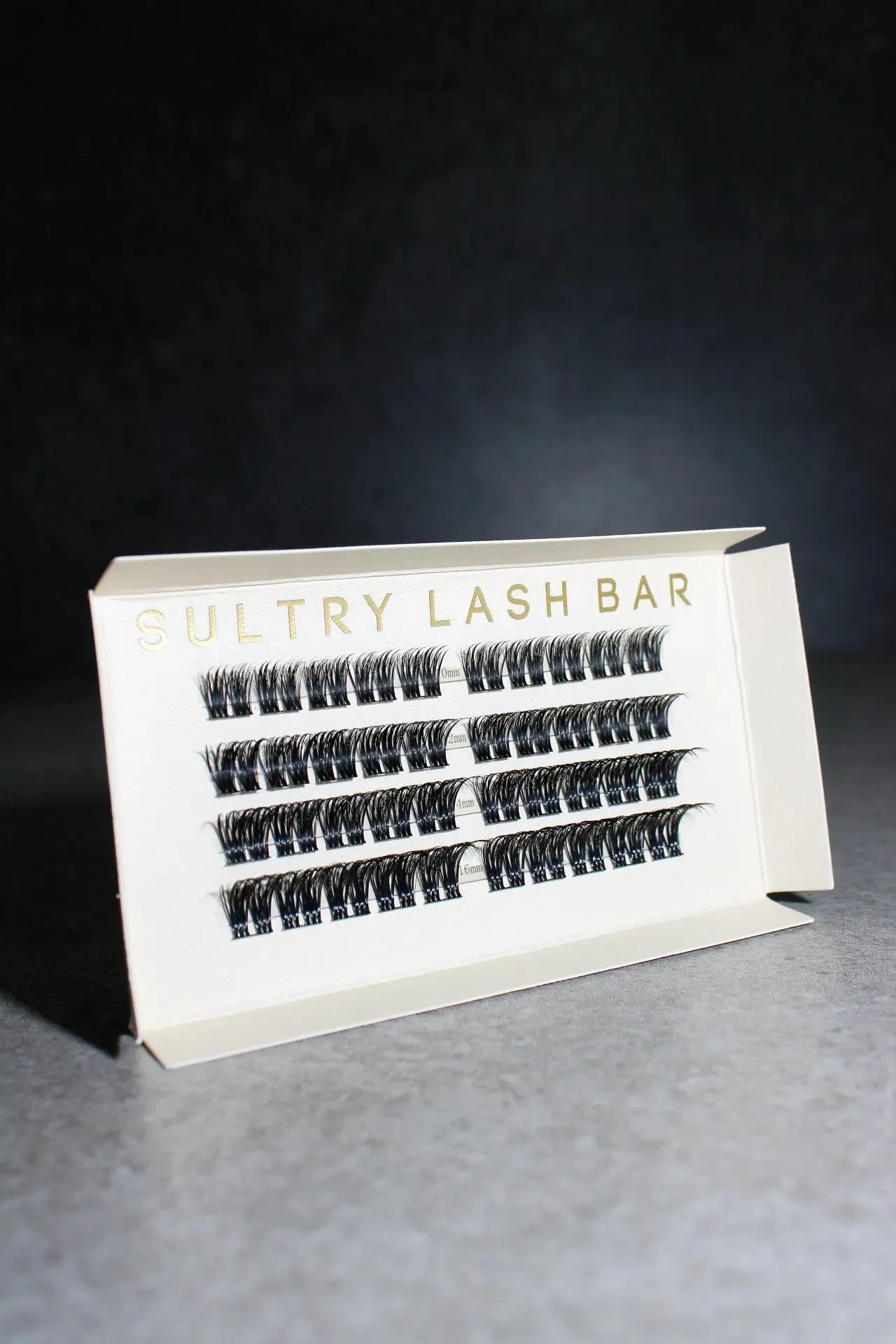 Eyelash extension tray from Sultry Lash Bar on a dark background
