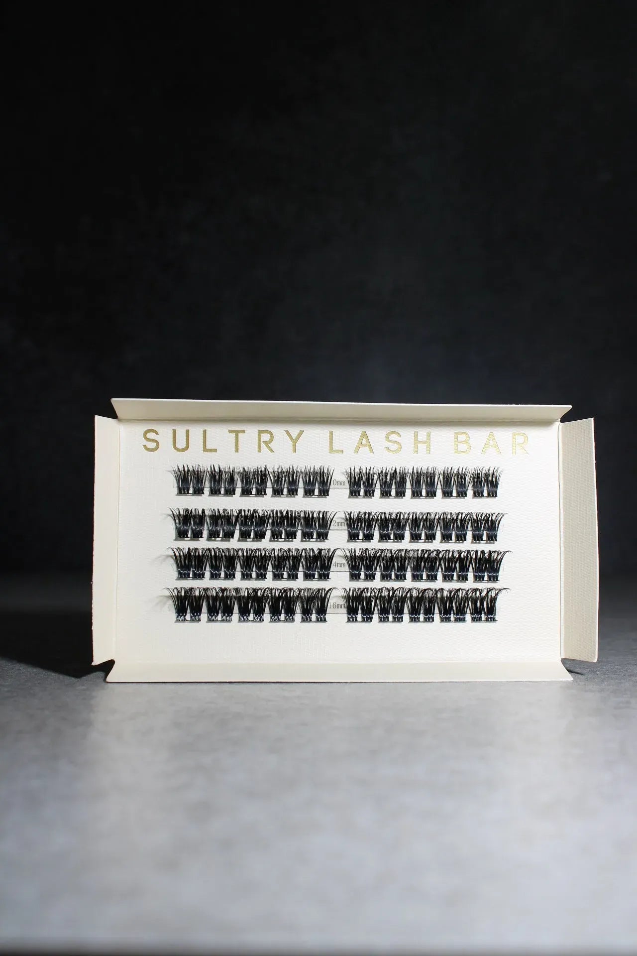 Sultry Lash Bar lash extension packaging on a dark background