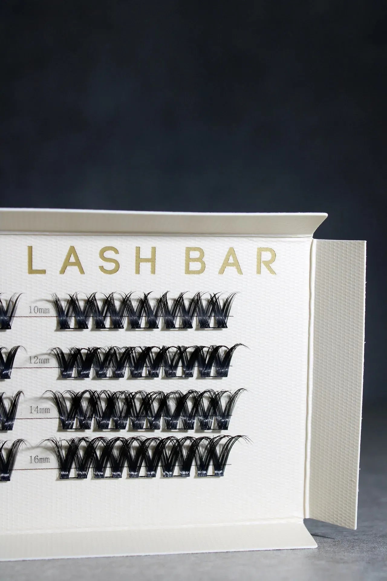Eyelash extension tray with 'LASH BAR' branding on a dark background