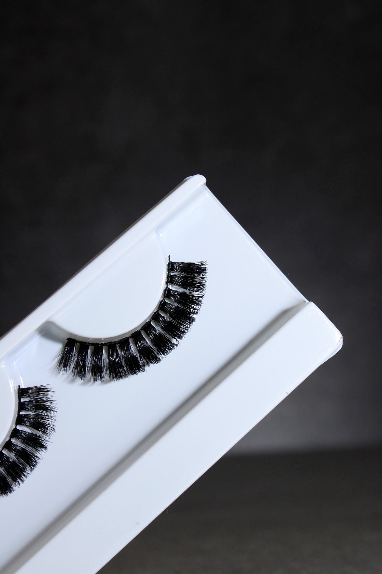 False eyelashes in a white box on a dark background