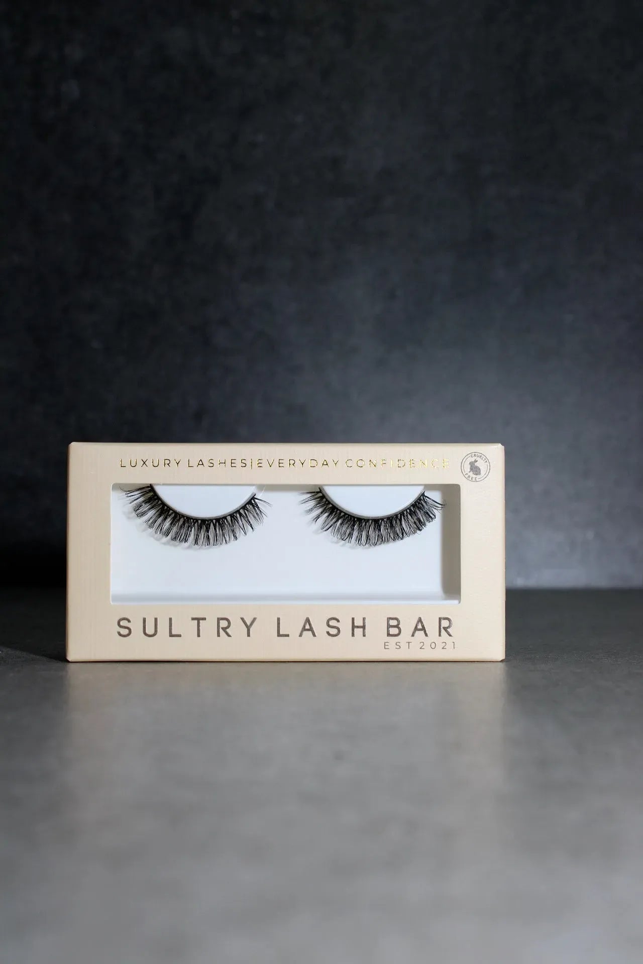 Box of Sultry Lash Bar false eyelashes on a dark background
