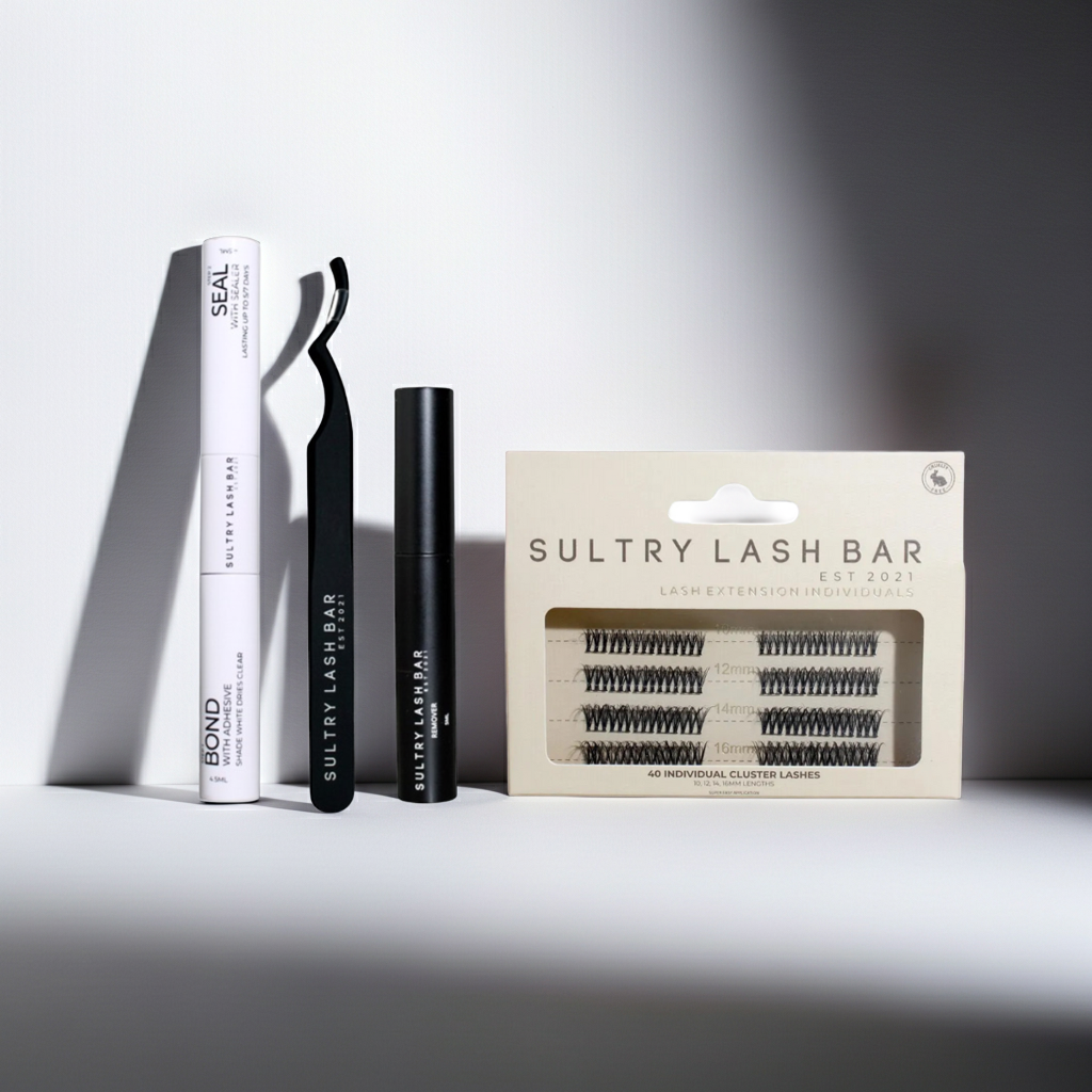 Sultry Lash Bar eyelash products including lashes, applicator, and packaging on a gray background