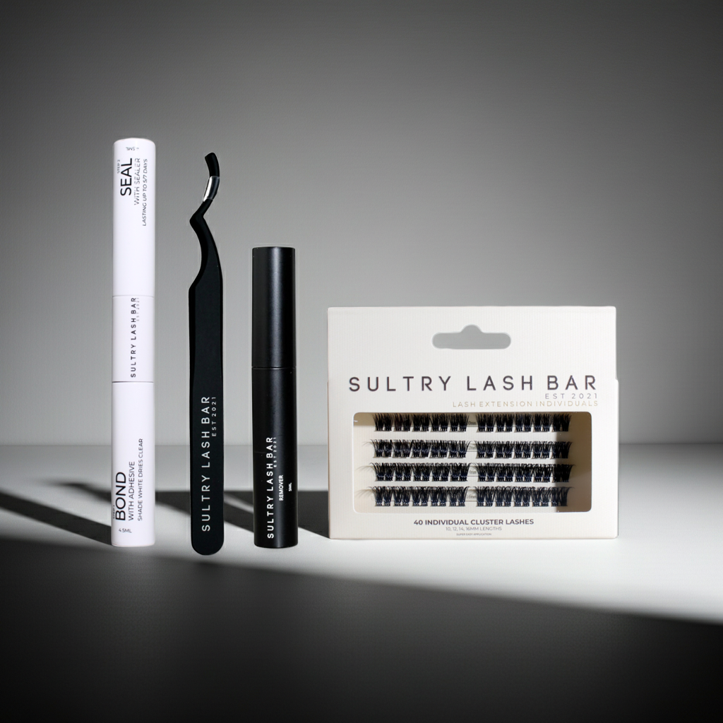 Sultry Lash Bar eyelash products including a tube, applicator, and packaging on a gray background