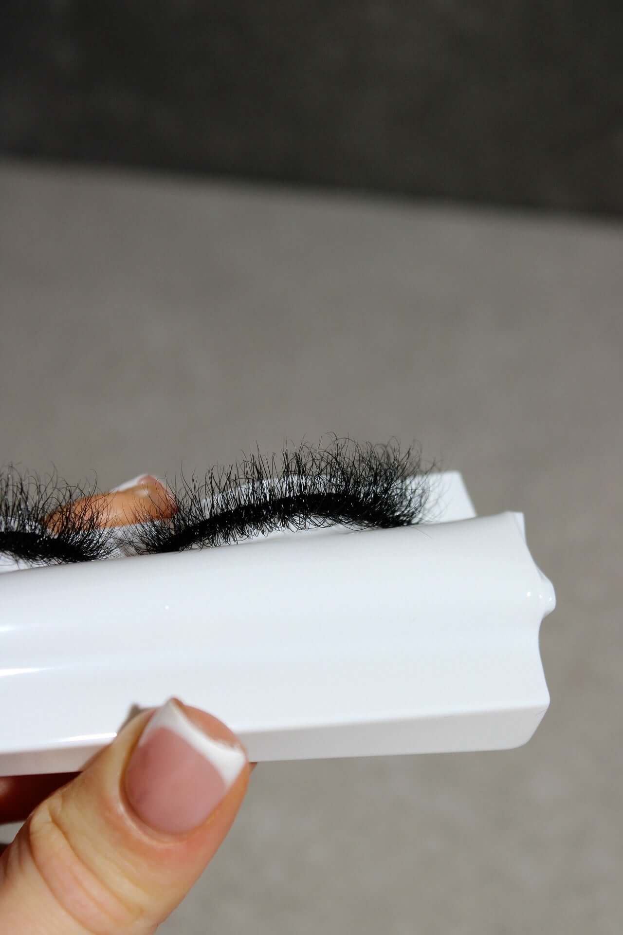 Healer Mega Volume Russian Strip Lashes displayed on a white tray, showcasing their dramatic length and texture.