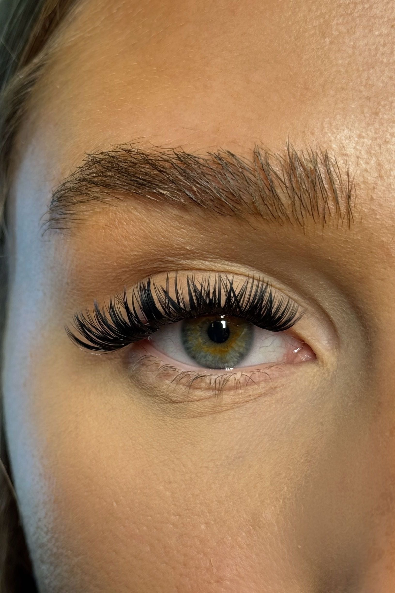Close-up of a person's eye with long eyelashes