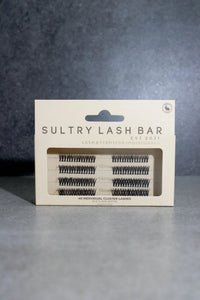 Sultry Lash Bar lash extension packaging on a gray background