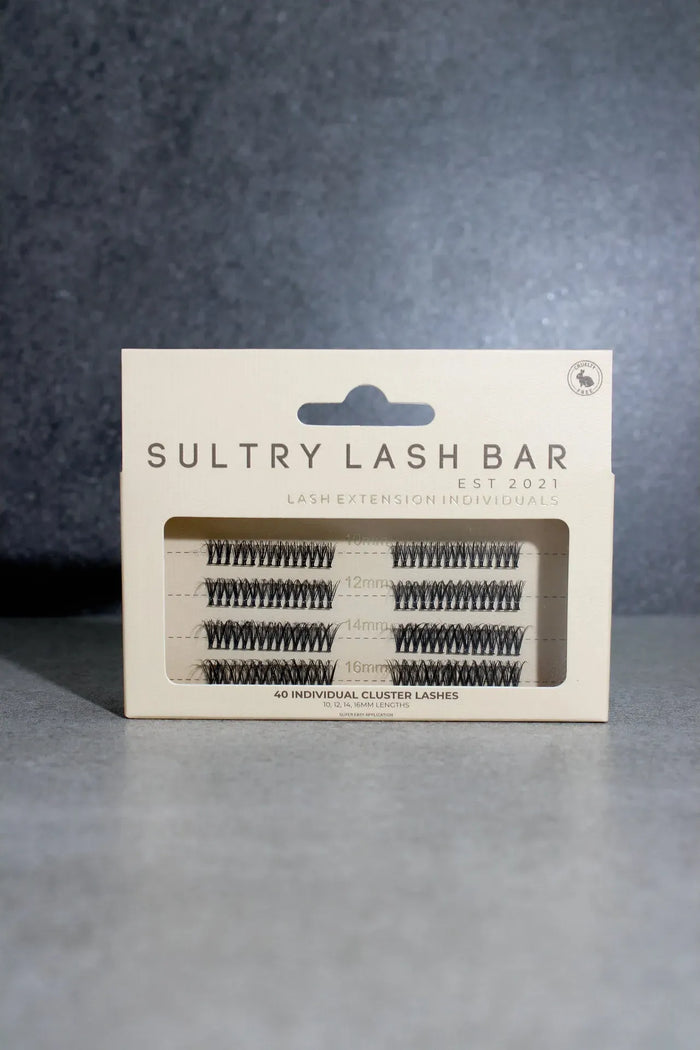 Sultry Lash Bar lash extension packaging on a gray background