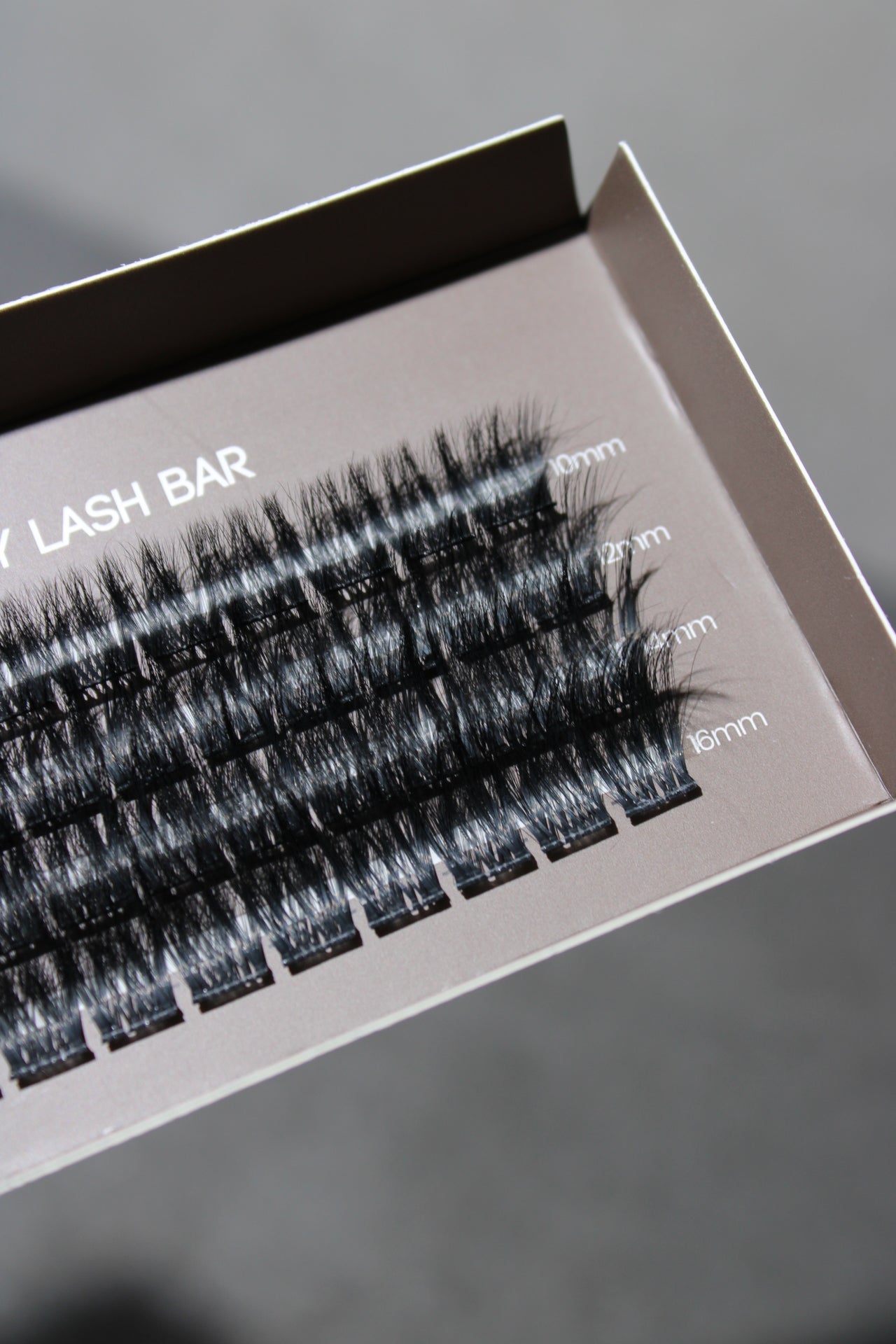 SL20 Korean fibre hair C curl DIY single cluster lash extensions displayed in an open box, showing the natural-looking, voluminous lash clusters.