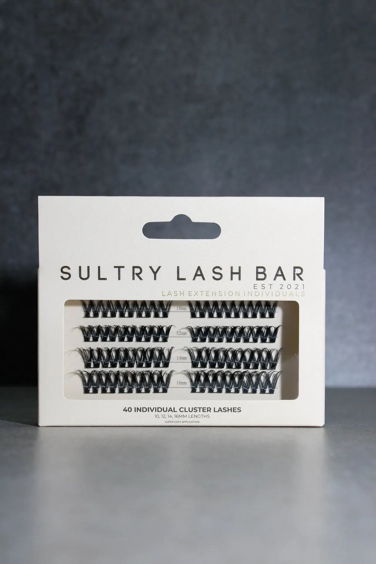 Packaging of Sultry Lash Bar false eyelashes on a dark background