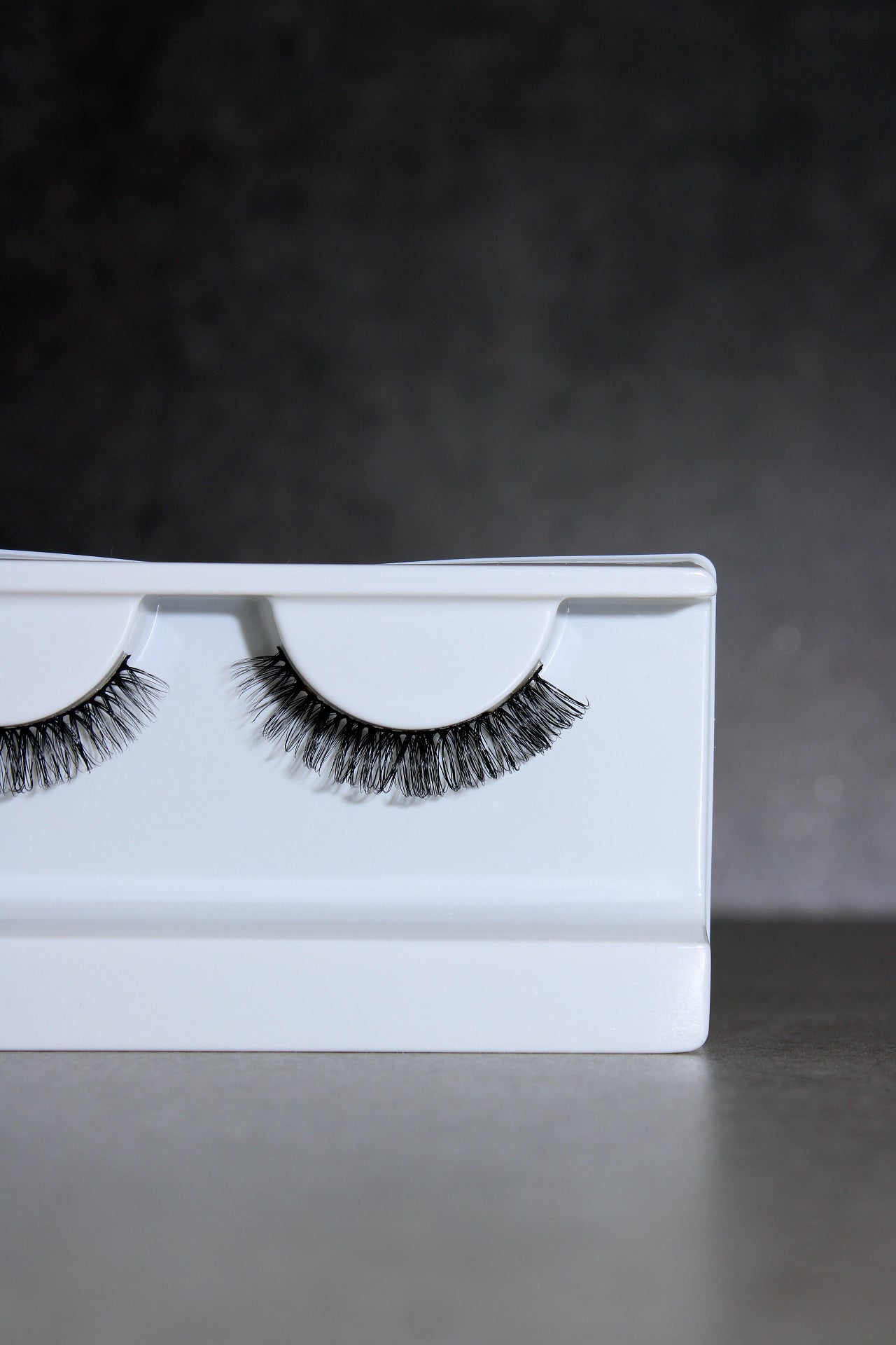 False eyelashes on a white card with a dark background