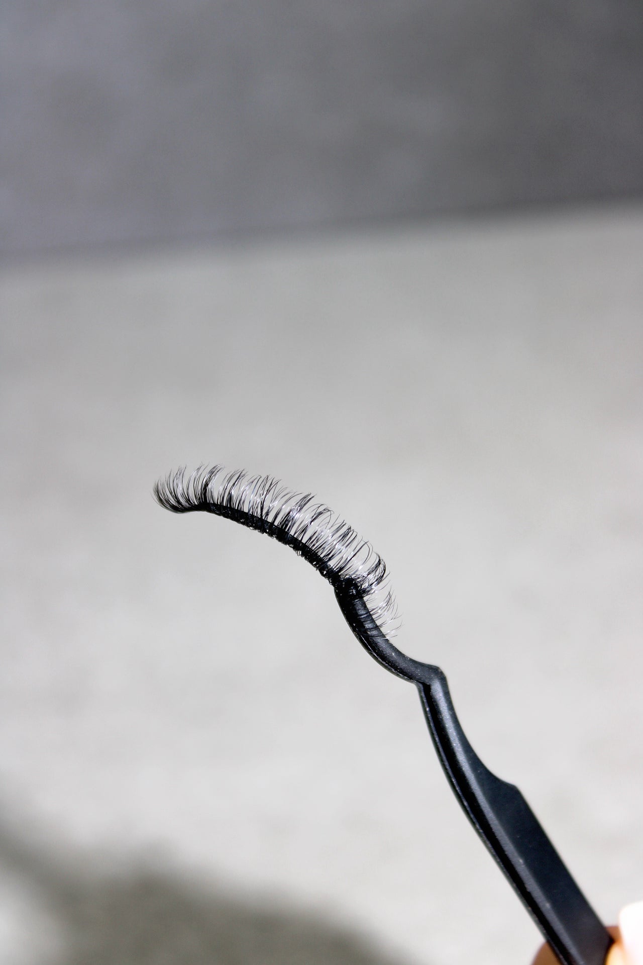 false strip lashes on a white tray gray background