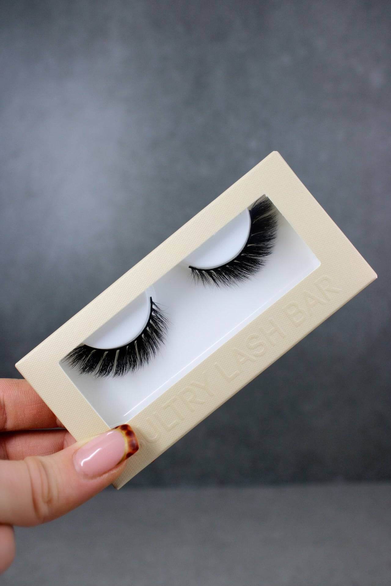 Cat eye winged out strip lashes in elegant packaging, showcasing natural eyelash extensions for a glamorous look.