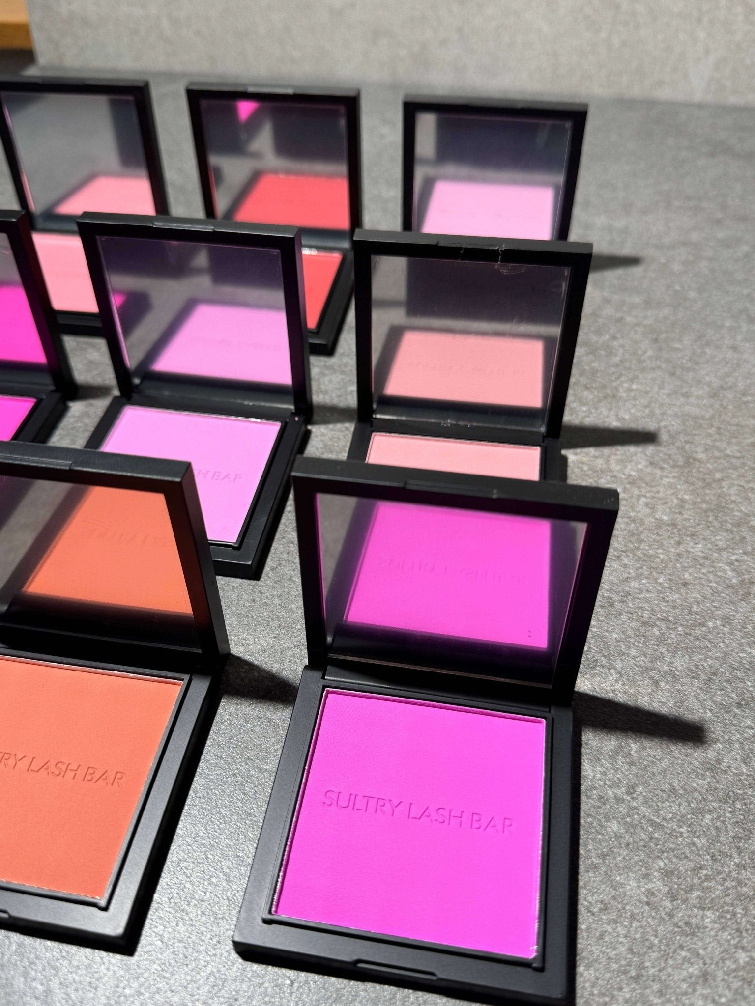 High-pigment powder blushes in sleek packaging from Sultry Lash Bar, showcasing vibrant shades for a long-lasting makeup look.