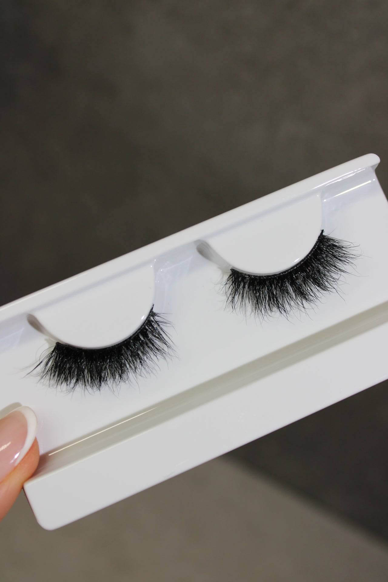 Luna Wispy Fluttery Half lashes in a white container, designed for a natural cat-eye look and reusable for any occasion.