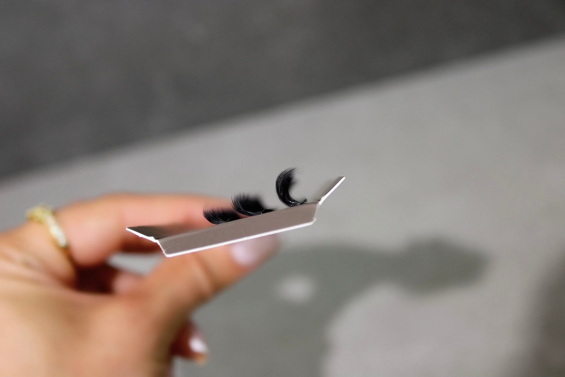 Close-up of SL14 DIY individual eyelash extensions in a compact tray, showcasing long-lasting, easy-to-apply false lashes for enhanced eye makeup.