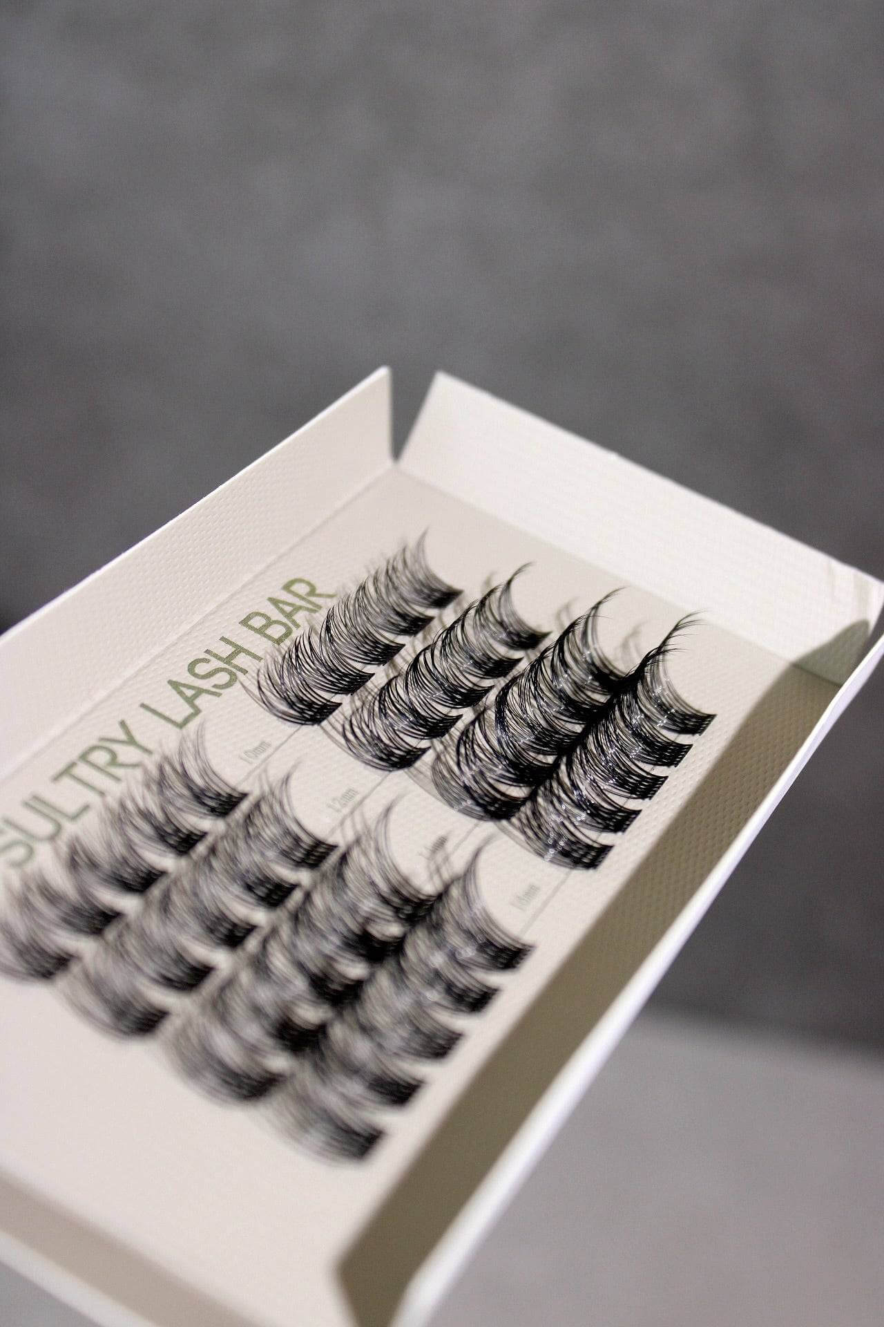 Close-up of SL03 Long Lasting DIY Individual Eyelash Extensions showcasing various lengths on packaging.